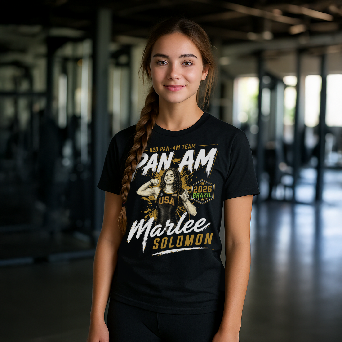 Person wearing a black t-shirt with 'Pan Am Team' and 'USA' text, standing indoors.
