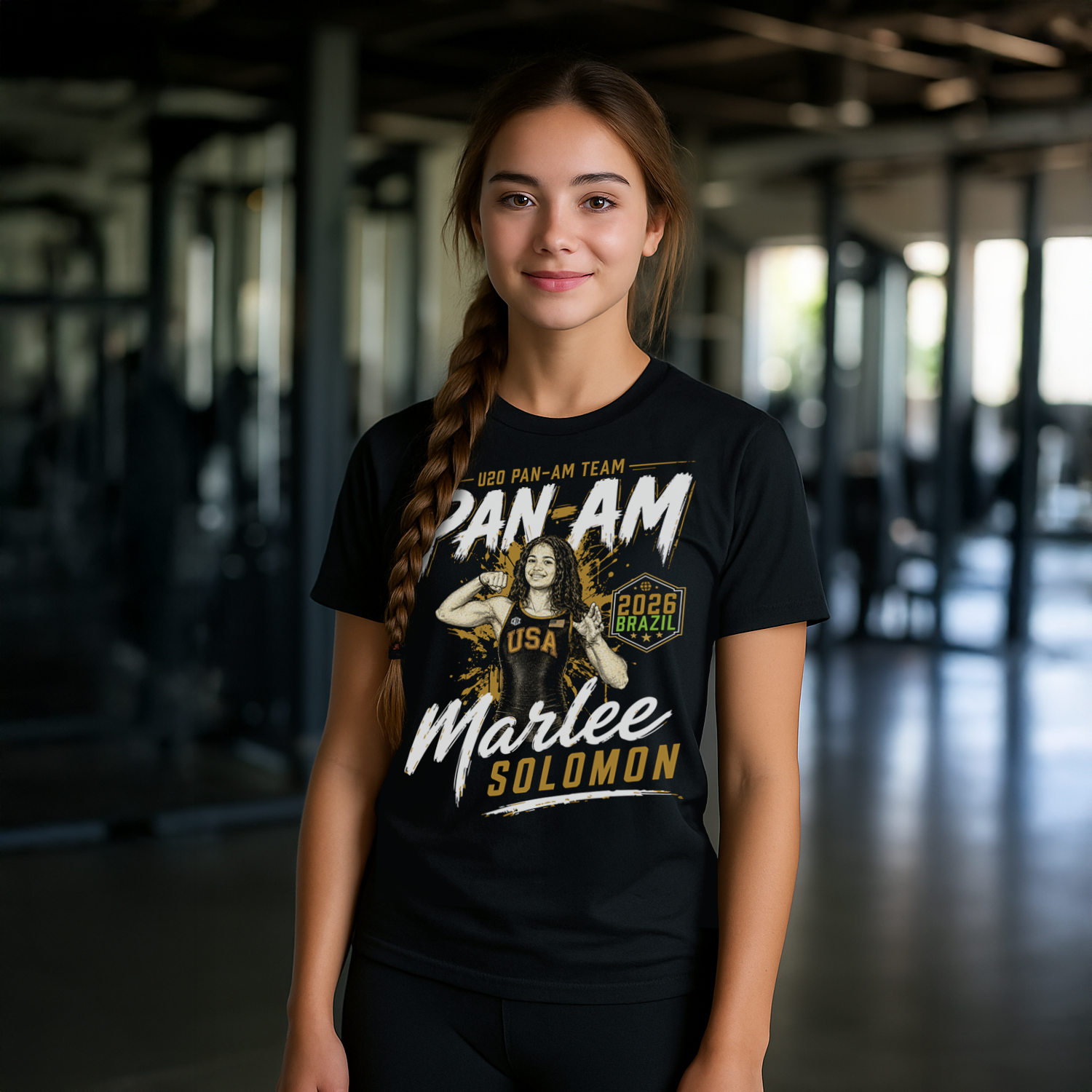 Person wearing a black t-shirt with 'Pan Am Team' and 'USA' text, standing indoors.